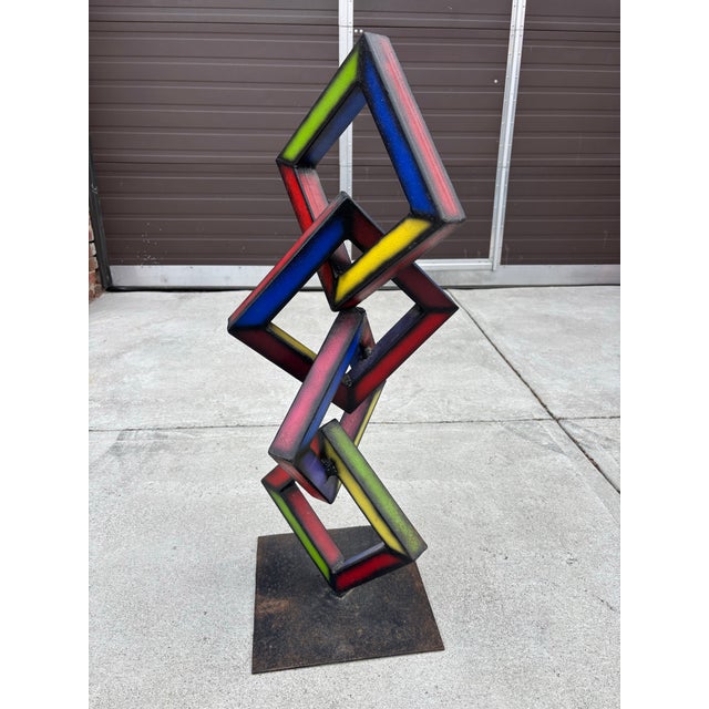 Welded inter-looping painted squares. Really nice bright colors! Sits very solid and looks good from every angle!