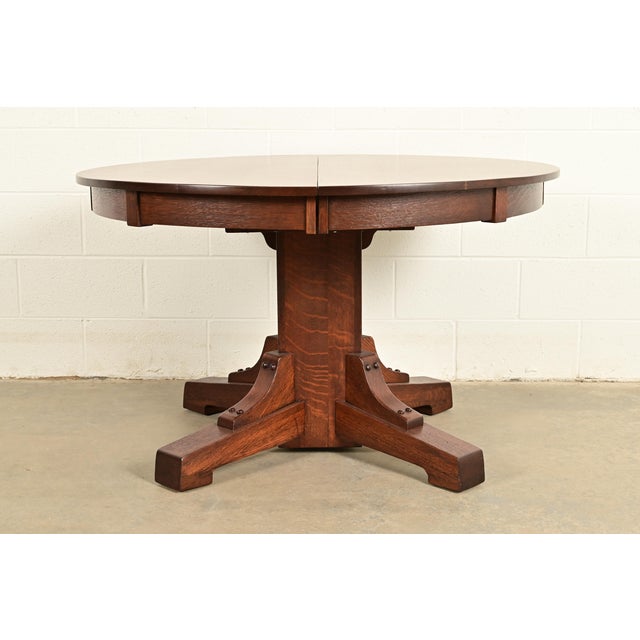 An exceptional antique Mission or Arts & Crafts period quarter sawn oak pedestal extension dining table By Stickley...