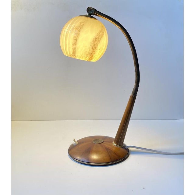 Exquisite and very versatile Italian desk or table lamp. It features a sunburst base and pin-striped rod in walnut....
