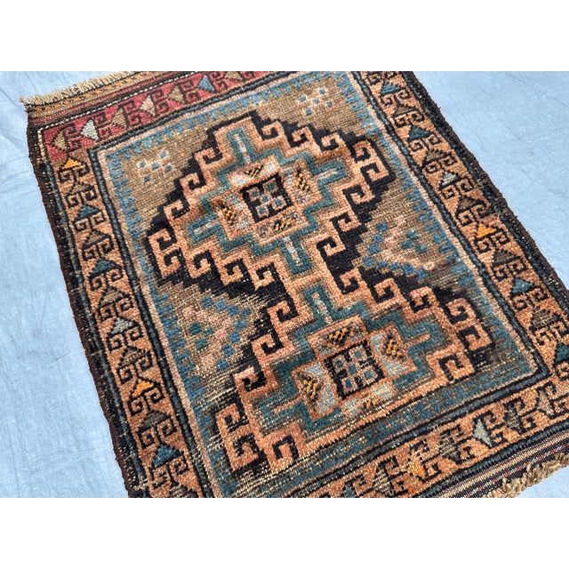 A rare antique Timuri Baluch tribal mat from the Khorasan region — a bold stepped rectilinear cruciform medallion with...
