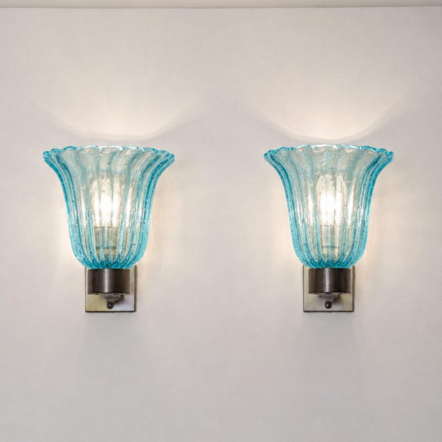 Elegant pair of Italian wall lights from the 1950s, attributed to Barovier & Toso and crafted with blue Murano glass...