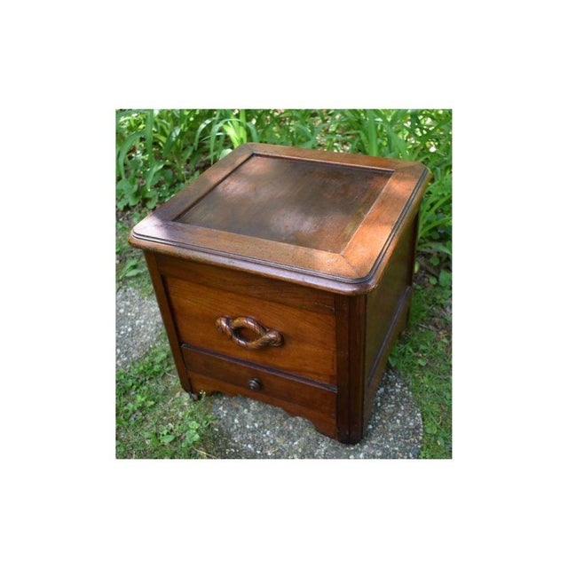 Of nautical interest, this 19th century English mahogany commode has rope twist carrying handles to either side. The top...