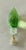 Multifaceted green acrylic candle bulb on brass base as lamp finial.
