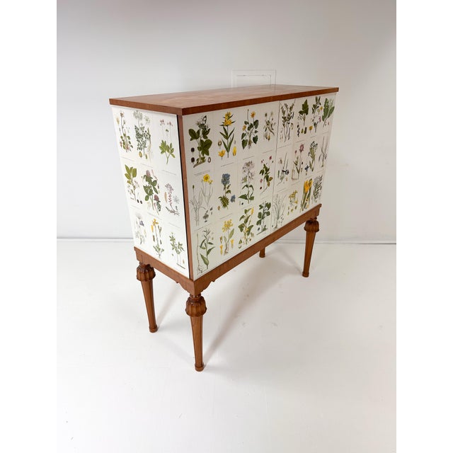 1940’s Swedish Cabinet later papered with illustrations by C.A. Lindman book Nordens Flora. Cabinet consists of large...