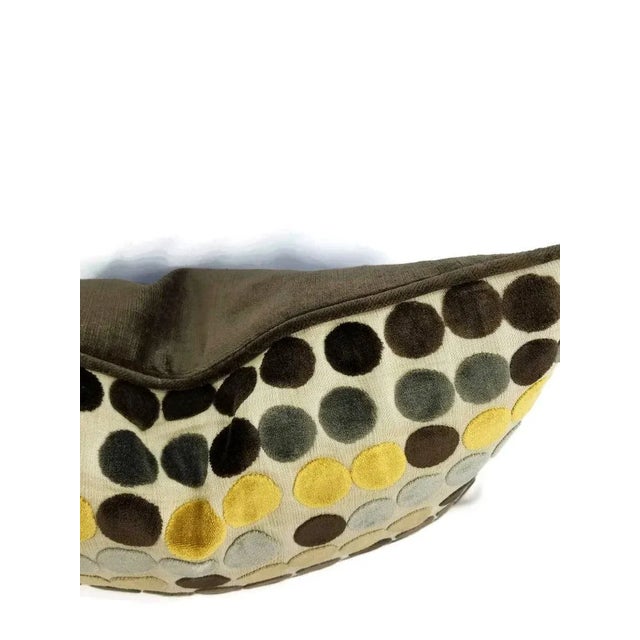 From Groundworks in Avery Dot in the color Mink and Gold. This pillow is backed and welted with Glant Fabrics Symphony...