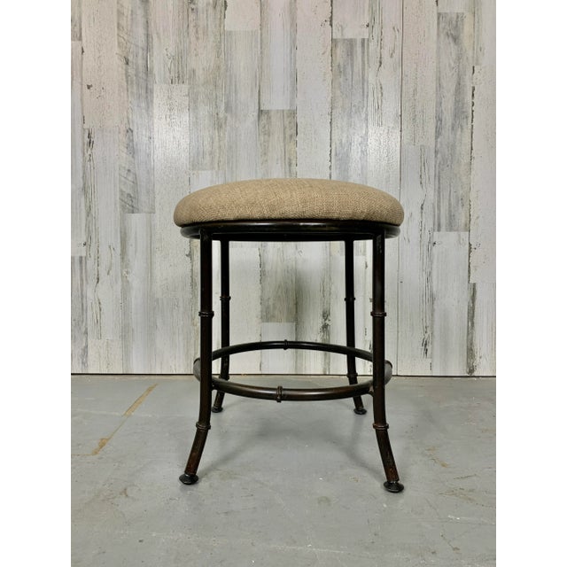 Faux bamboo metal stool in a bronze finish with new upholstery. There are three available.
