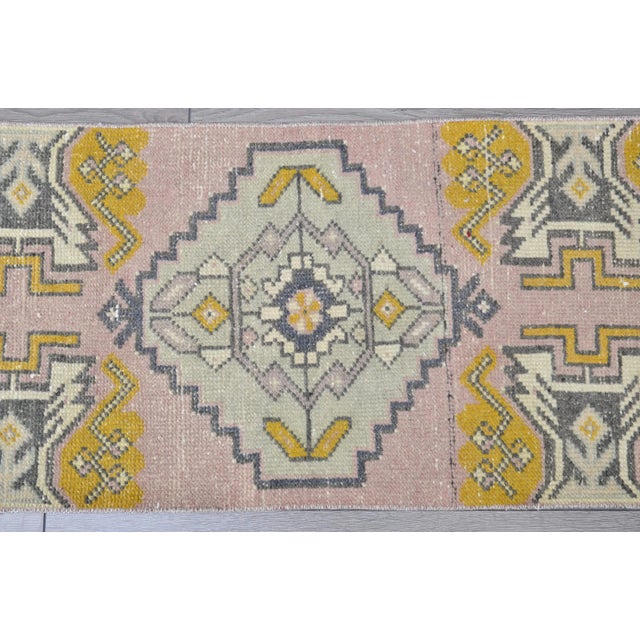 This is a vintage Turkish Oushak rug from the 1960s. The piece was hand-knotted.