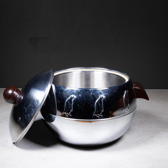 ABOUT Mid-century Penguin ice bucket with brown Bakelite handles and lid knob. Mostly used as ice bucket, but the piece...