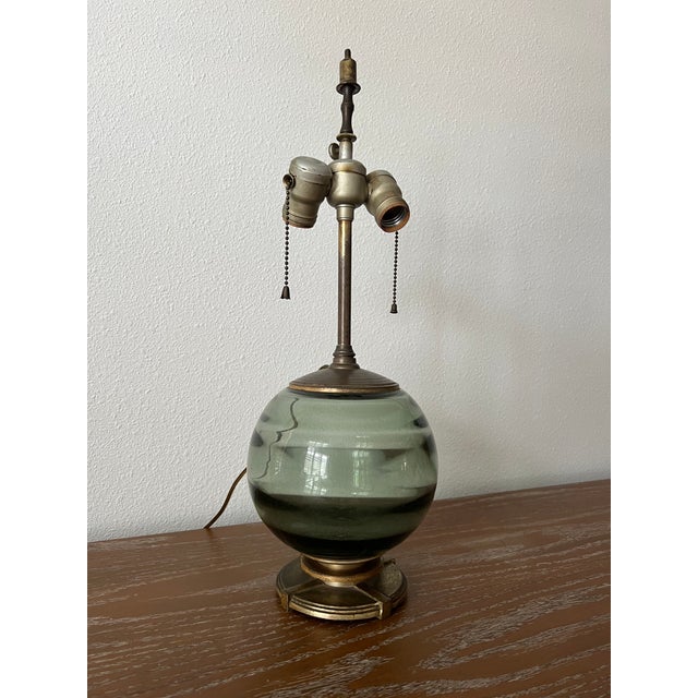A beautifully proportioned petite 1930s Art Deco table lamp featuring a striking smoke blue-green art glass globe paired...
