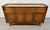 Elevate your space with this stunning Mid-Century Modern sculpted walnut buffet, a timeless statement piece that embodies...