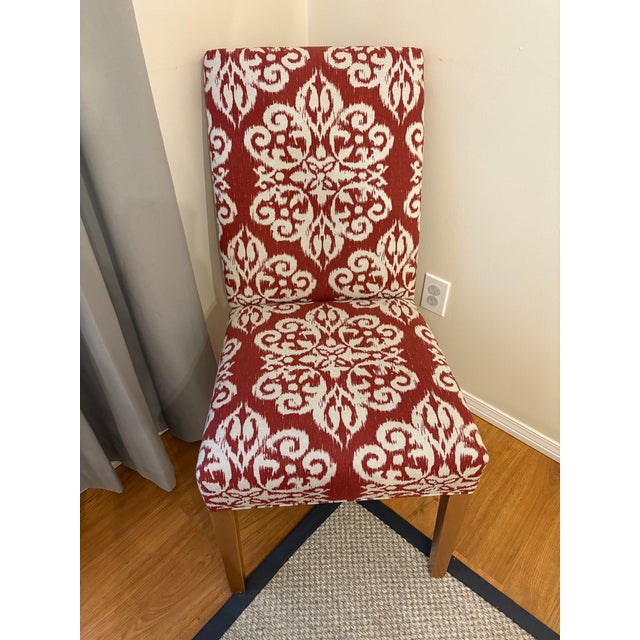 Set of 8 Ethan Allen “Thomas” side chairs in a red patterned fabric (Grade G). Solid construction with comfortable...