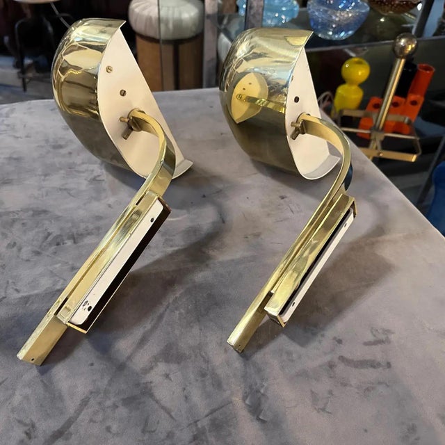 A pair of high quality solid brass wall sconces designed and manufactured in Italy in the Eighties by Lumi. They are in...