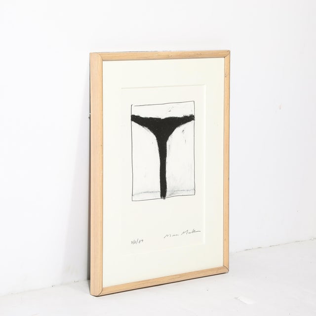 This graphic Mid-Century Modernist Abstract Lithograph in White and Black Signed Mona Mark originates from the United...
