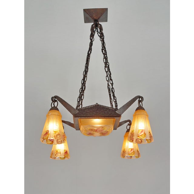 Marcel Vasseur & EJG A French 1925-1930 art deco chandelier in wrought iron by the Parisian blacksmith M.Vasseur. It holds...