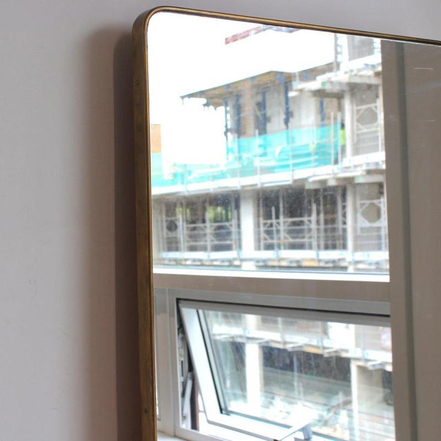 Large mid-century Italian wall mirror with brass frame (circa 1960s). This mirror is simply elegant and characterful in a...