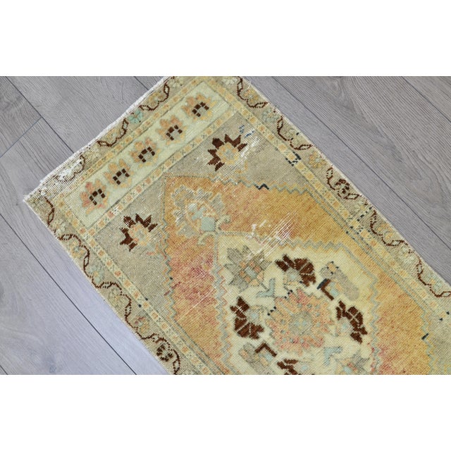 This is a vintage Turkish Oushak rug from the 1960s. The piece was hand-knotted.