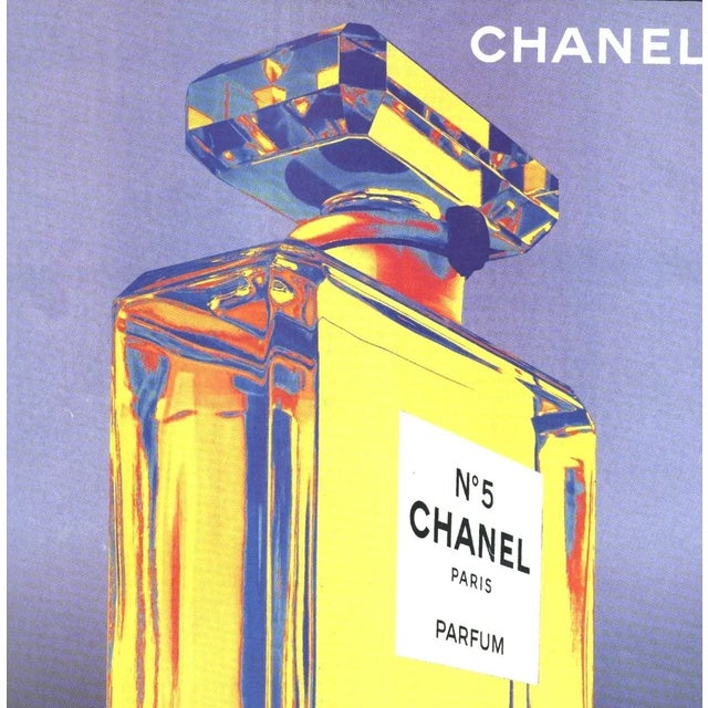 This is an original advertisement for Chanel No.5 perfume that appeared in a 2003 French magazine. It is a strong graphic...