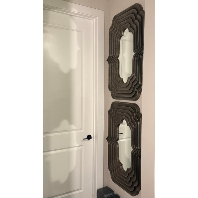 Pair of 40” x 30” Sequential Mirrors by Global Views in the Antique Silver finish. With their sculptural layered frame and...