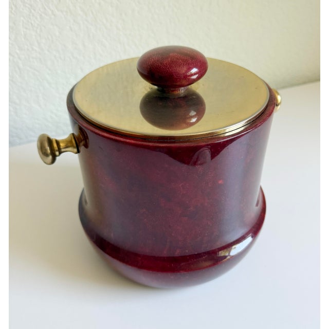 A vintage ice bucket created by the renowned Italian designer Aldo Tura and produced by maker Macabo. Crafted from dyed...