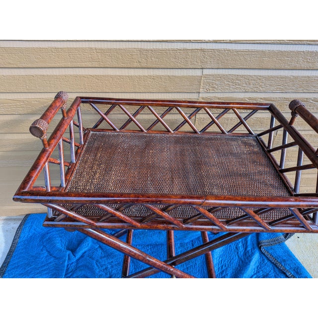 Vintage butler tray serving table that feature a dark stained finish and a distinctive woven rattan panels. Looks like...