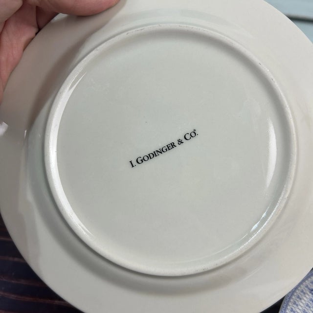 Beautiful set of four luncheon plates by I. Godinger & Co., featuring classic blue transferware designs on crisp white...