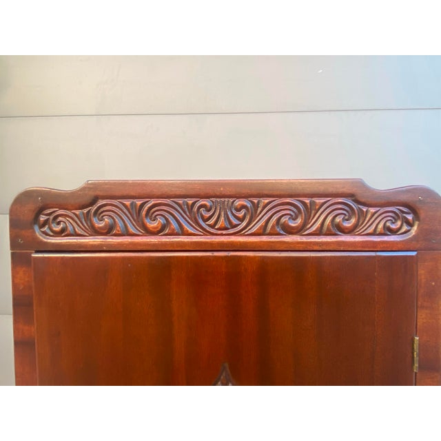 Late 19th/early 20th century single-door music cabinet: scroll-carved crest rail, applied oval fan medallion, shaped...