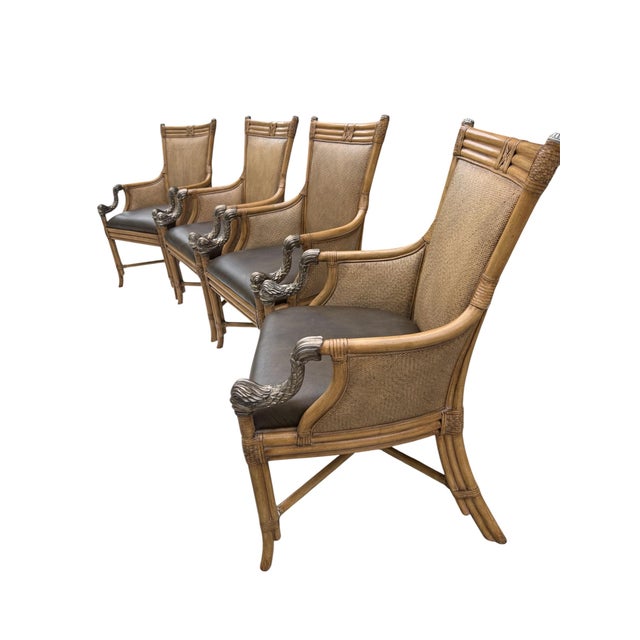 A striking set of four Asian-inspired armchairs featuring beautifully detailed faux-bamboo frames, intricate woven panels,...