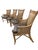A striking set of four Asian-inspired armchairs featuring beautifully detailed faux-bamboo frames, intricate woven panels,...