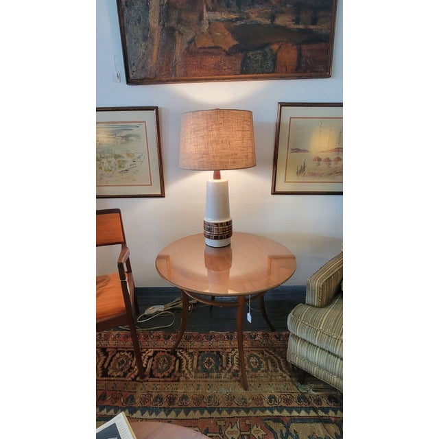 Showcase your modern taste with this stunning Marshall Studios table lamp. Crafted from high-quality ceramic and walnut,...