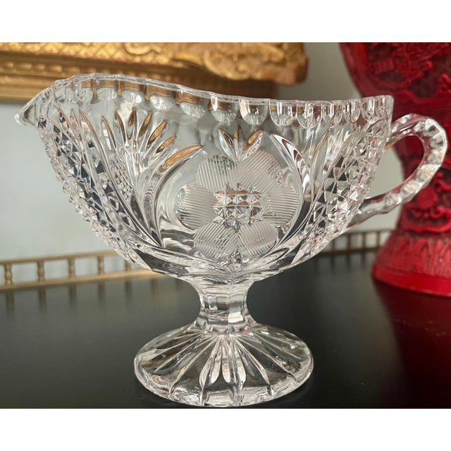 Absolutely gorgeous clear crystal with etched floral motif gravy boat. Features a spout for easy pouring and a handle for...