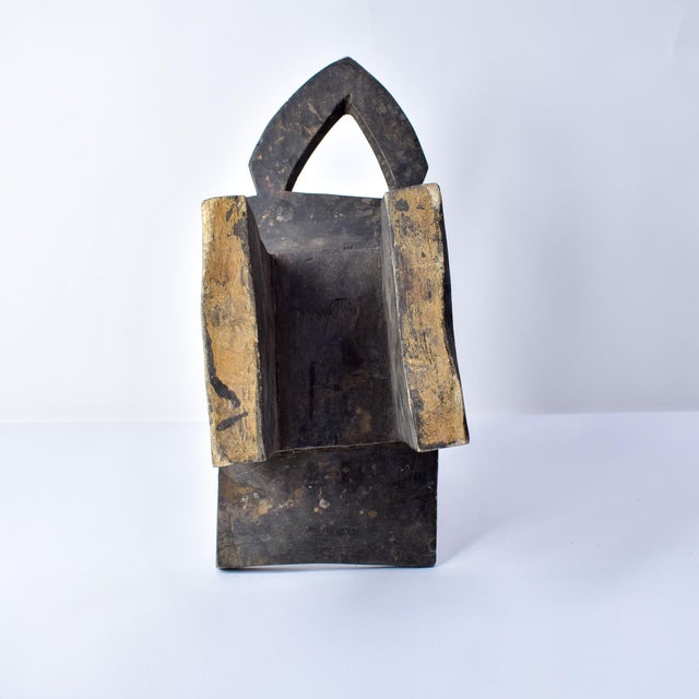 This small wooden stool was carved by the Bobo people of Burkina Faso. Stools like this served both as utilitarian objects...