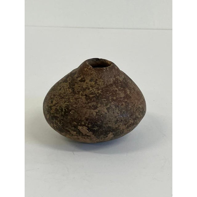 This antique primitive clay pot, dating from the late 19th to early 20th century (circa 1880s–1920s), is hand-formed in a...