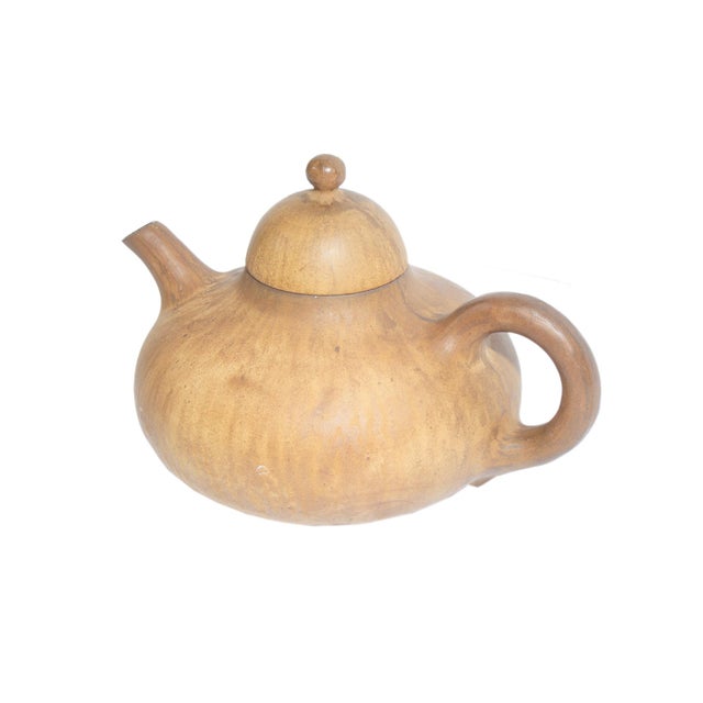A 1951 ceramic teapot designed by the Danish designer Jørgen Møller-Petersen. Brown in color, this teapot has a short...