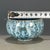 A charming Chinese ceramic tea cup or small bowl. The piece features a striking, highly textured "splash" or "flambé"...