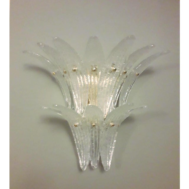Italian wall light with clear Murano palmette glass leaves hand blown in Graniglia technique to produce granular textured...