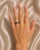 Elegant 14K white gold wedding band featuring brilliant round diamonds totaling 0.2 carats and natural sapphires weighing...