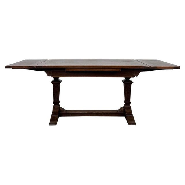 A handsome and highly practical early 20th-century English dining table, finely constructed in oak and distinguished by...