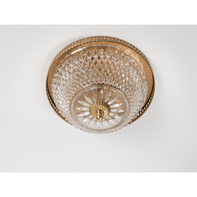 A vintage 10" flush mount 2-light fixture made of brass with a pressed glass patterned lampshade. Spain circa 1960s....