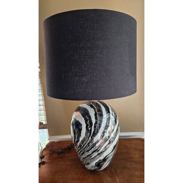This one-of-a-kind vintage table lamp is a true showstopper. Featuring hand-painted black and white detailing and a...