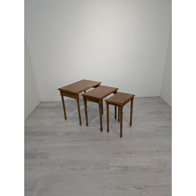 Set of Mid-Century Style Marquetry Three-Table Tables A set of three mid-century style wooden tables. Made of wood, they...