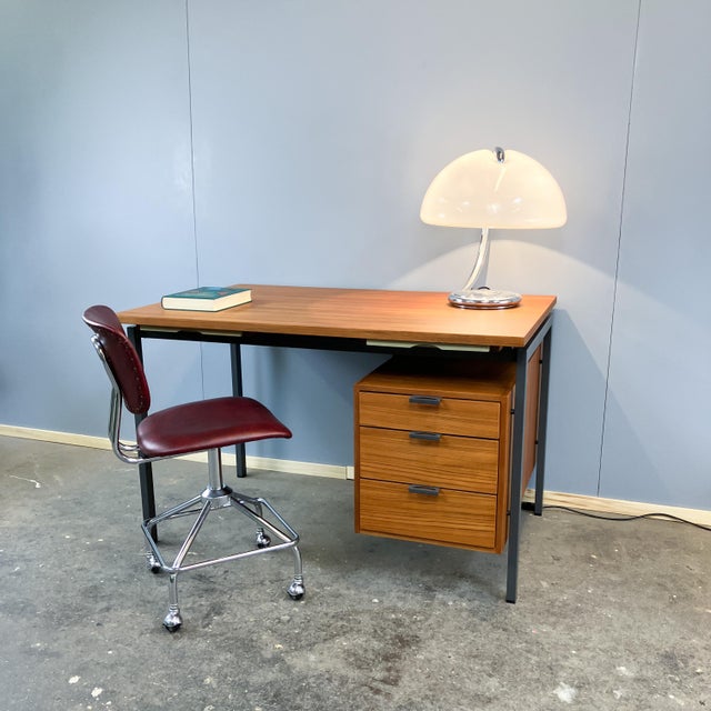 This iconic desk was designed in the 1960s by Herbert Hirche, a Bauhaus student and collaborator of Mies van der Rohe, in...