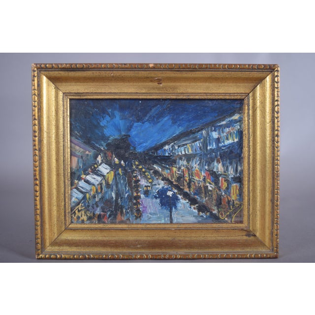 Impressionist-style night street scene painted in oil on panel, dating to the 1950s and signed Cuca. A boulevard recedes...