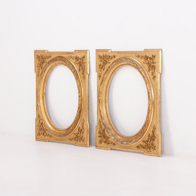 A Pair of Napoleon III style giltwood and gesso picture frames, 19th C. having oval openings and relief branch and leaf...