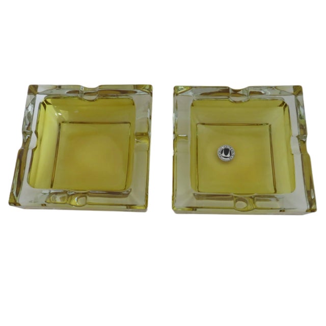 A pair of 1970s Walther-Glas modernist molded glass ashtrays in amber and clear, inspired by 1930s Art Deco streamline...