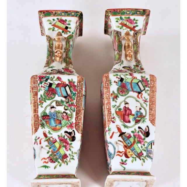 A pair of Mid 19th Century Chinese export Famille Rose Mandarin vases with foo lion handles This pattern is well known and...