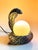 Speckled ceramic lamp in the shape of a cobra, with a white opaline glass globe This piece has an attribution mark, I am...
