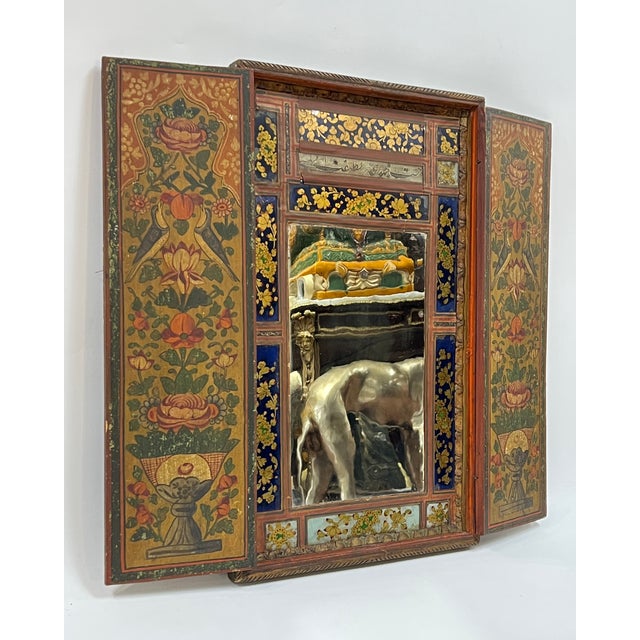 Antique (early 20th century) Persian polychrome wooden wall wedding mirror with doors left and right that open to reveal a...