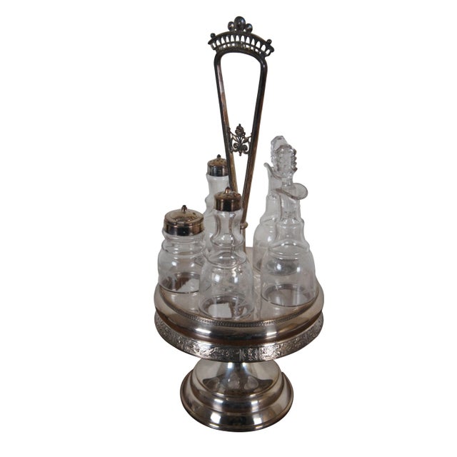 Antique Victorian Reed & Barton cruet condiment set featuring pressed and etched glass bottles with ornate footed...