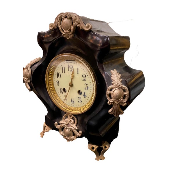 Antique French black gilded clock. Signed France on back. Has it's key. 9.5” Wide x 5” Deep x 10.5”