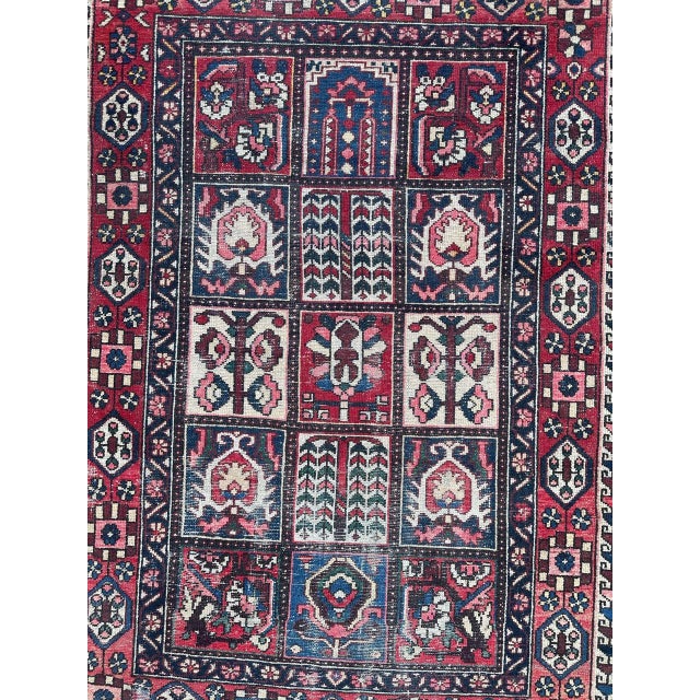 Beautiful vintage distressed Bakhtiar rug with a beautiful geometrical and stylized design with blue red, pink and...